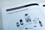 The illustration shows various materials needed to conduct an experiment to detect starch in food. These include sugar, semolina, various samples in bowls, and some laboratory instruments such as pipettes and spoons.