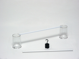 Two transparent beakers stand on a white base, connected by an elongated white tube. Next to the beakers is a black hook and another white tube, which can be used for educational experiments.