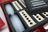 A red case houses various experimental materials, including transparent beakers and wooden pieces with through holes. The items are securely organized in custom-fit foam padding for easy access.