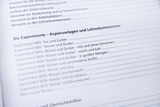 A list of experiments is shown, focusing on various aspects of water and sugar. The experiments are listed for educational use and serve as photocopiables and teacher commentaries.