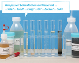 A row of test tubes shows various liquids being mixed with water, including vinegar, oil, sugar, salt, and soil. Next to them are additional containers containing ingredients such as cooking oil and garden soil, encouraging experimentation.